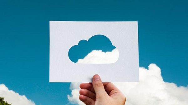 Hand holding blue cloud computing icon representing digital technology