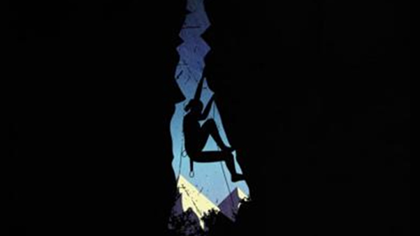 Silhouette of rock climber scaling mountain wall representing ambition