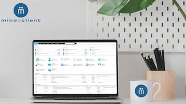 MindaClient CRM software dashboard displayed on laptop screen
