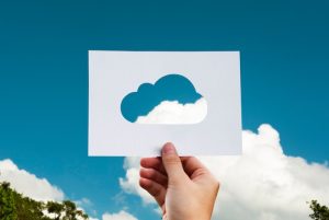 Hand holding blue cloud computing technology icon