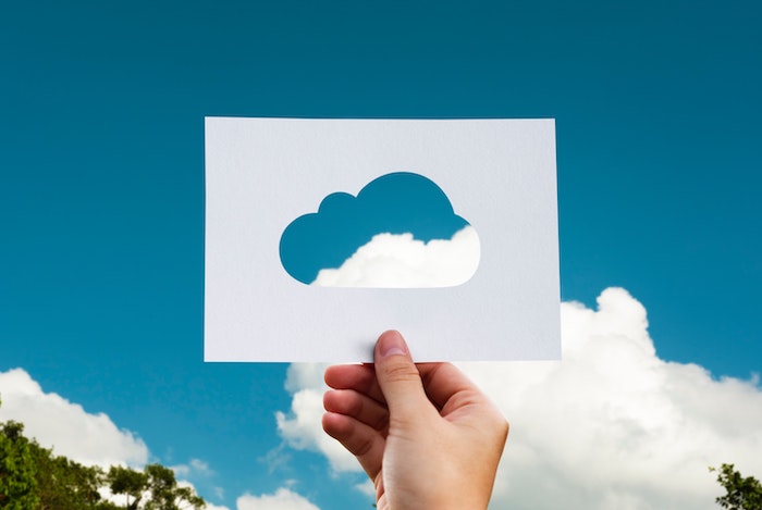 Hand holding blue cloud computing technology icon