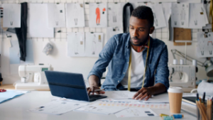 Young professional man working on laptop in modern office